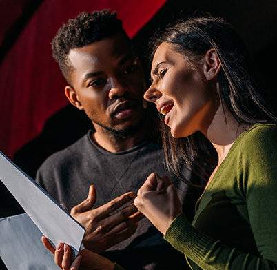 multiethnic actor and actress having rehearse on stage in theater